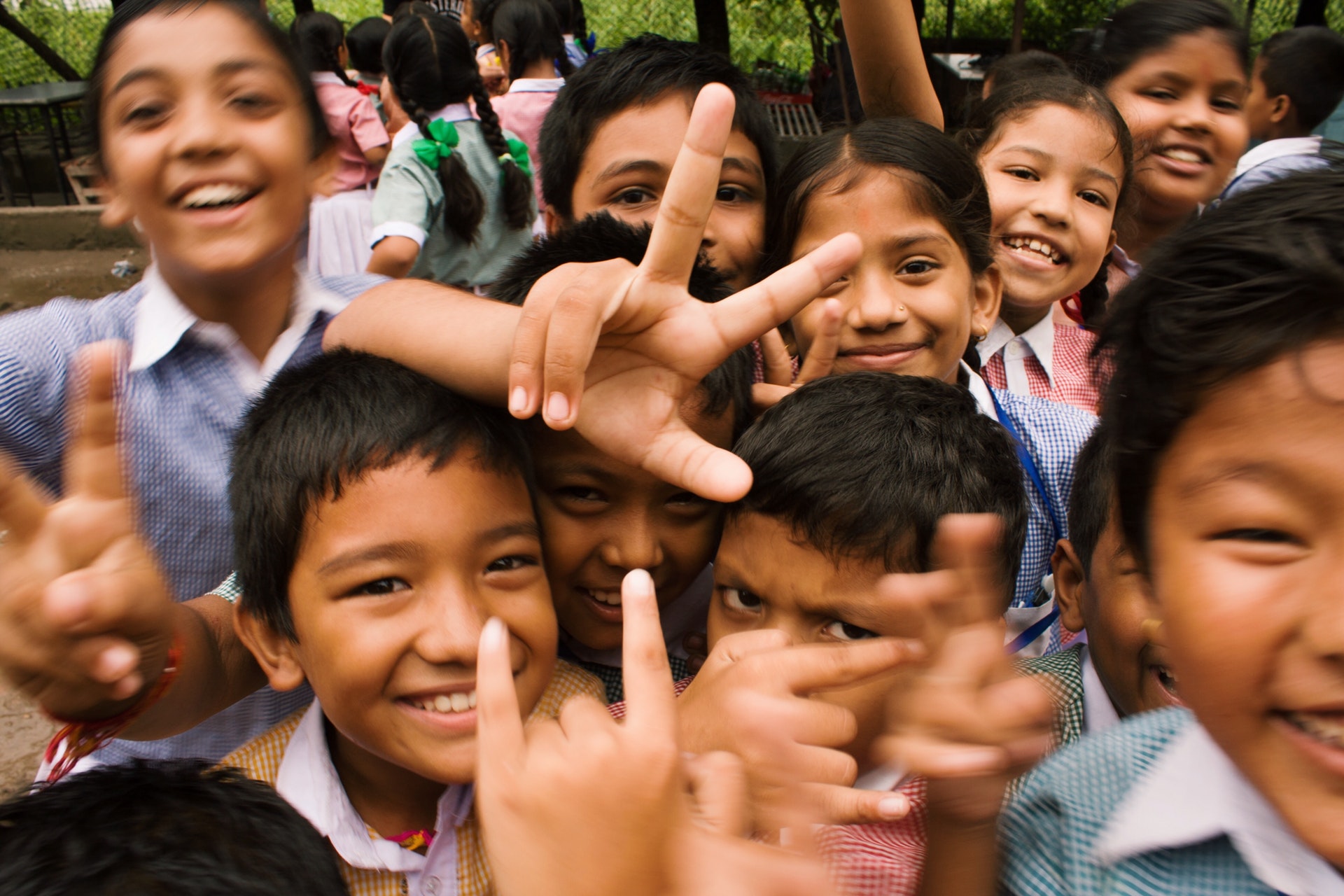 Smiling children crowding round camera